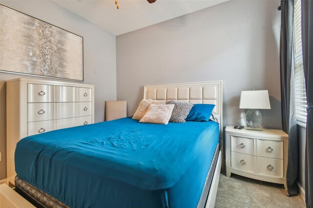 carpeted bedroom with a ceiling fan