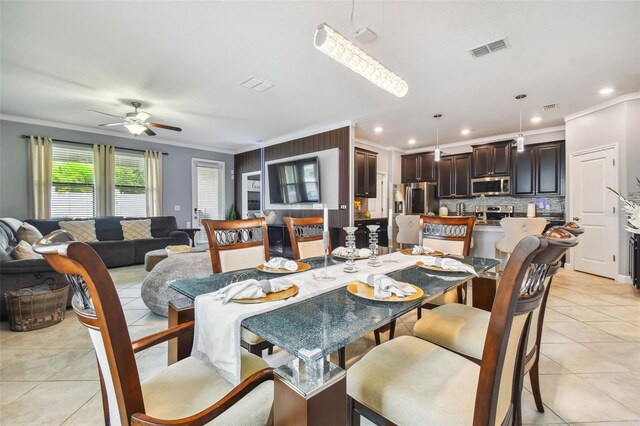 dining area featuring ornamental molding, a ceiling fan, light tile patterned flooring, and visible vents