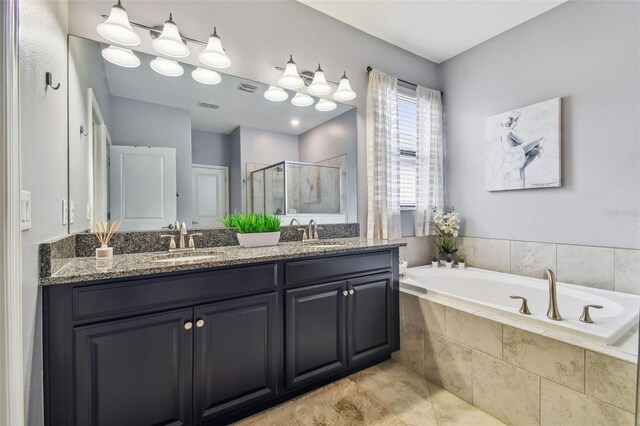 full bath with a sink, double vanity, a shower stall, and a bath