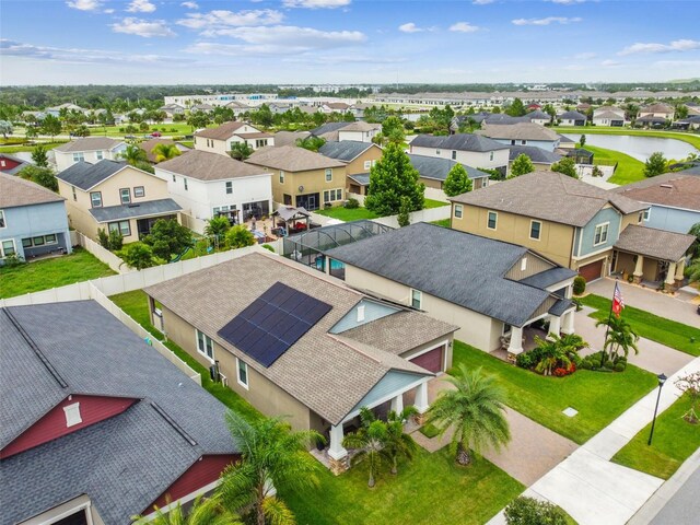 drone / aerial view featuring a water view and a residential view