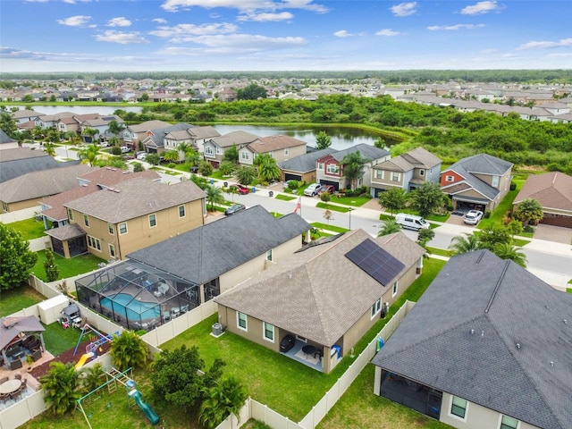 drone / aerial view featuring a water view and a residential view