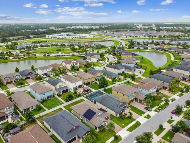 birds eye view of property with a water view and a residential view