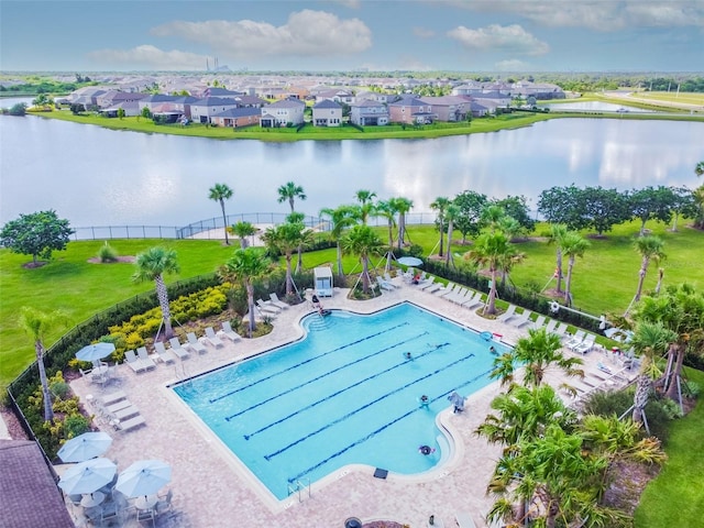 community pool featuring a water view and a residential view