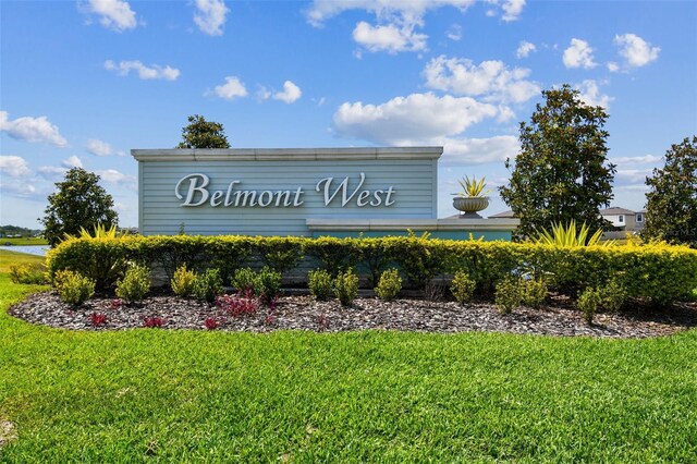 community / neighborhood sign with a lawn