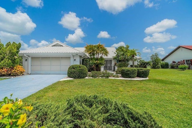 single story home featuring a garage and a front lawn