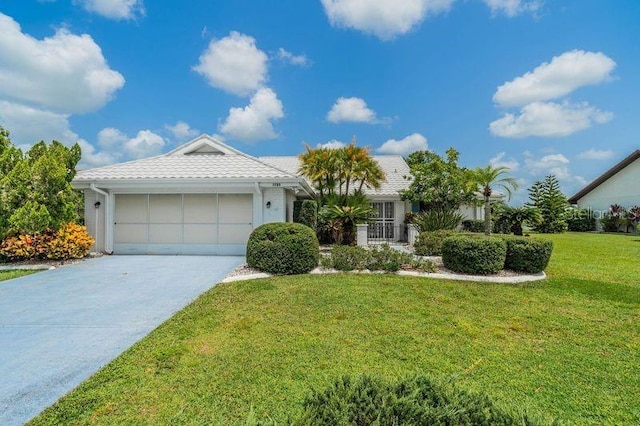 ranch-style house with a garage and a front lawn