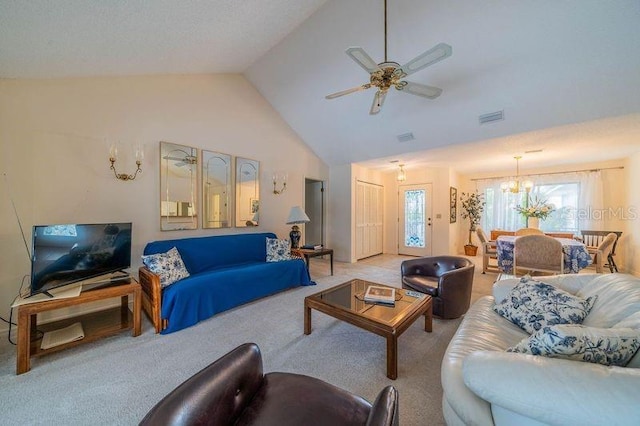 living room with lofted ceiling, ceiling fan with notable chandelier, and light carpet