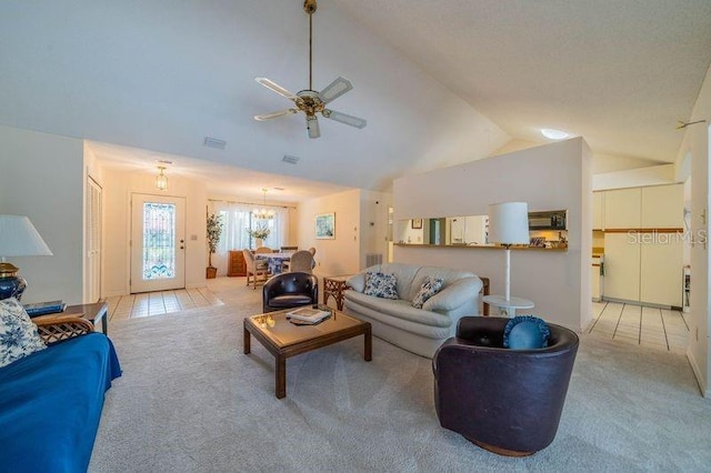 carpeted living room featuring vaulted ceiling and ceiling fan