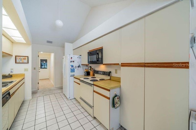 kitchen featuring white appliances, vaulted ceiling, and light tile patterned flooring