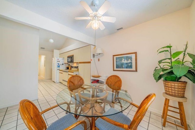 dining space featuring ceiling fan and light tile patterned floors