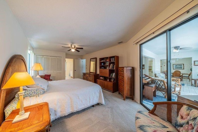 carpeted bedroom featuring ceiling fan and a closet