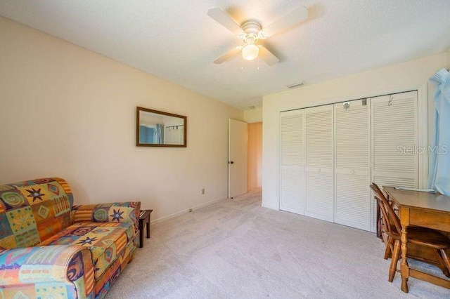 office space with light colored carpet and ceiling fan