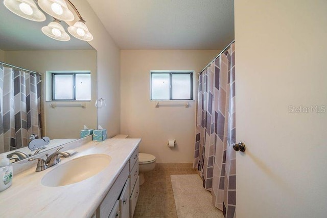 bathroom featuring vanity, tile patterned flooring, and toilet