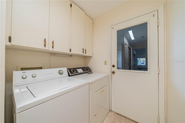 laundry area featuring cabinets and washing machine and clothes dryer