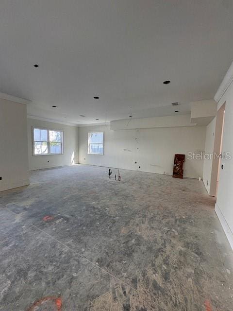 empty room featuring crown molding