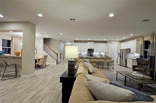 living room with light hardwood / wood-style flooring