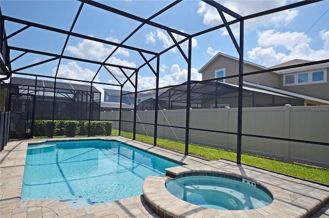 view of pool with an in ground hot tub and a lanai