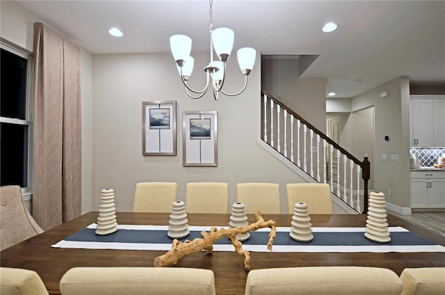 dining room with wood-type flooring and an inviting chandelier