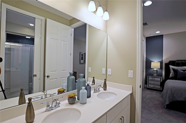 bathroom with vanity and a shower with shower door