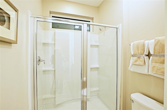 bathroom featuring toilet and walk in shower