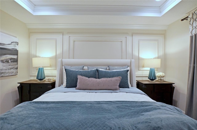 bedroom featuring a tray ceiling and ornamental molding