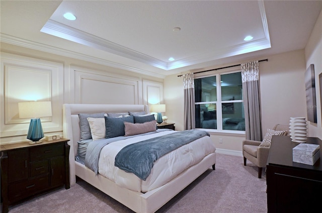 carpeted bedroom featuring a tray ceiling and ornamental molding