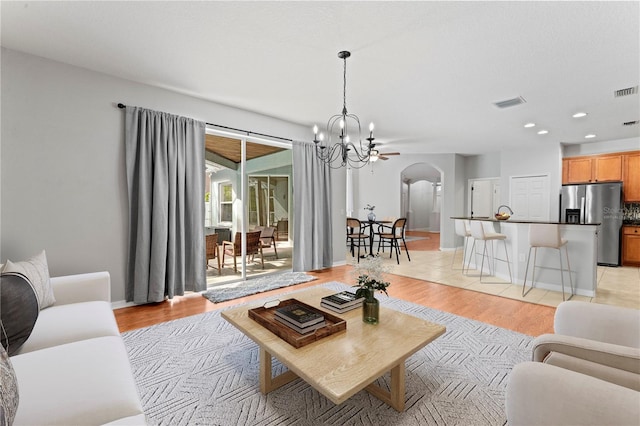 living room with light hardwood / wood-style flooring and a notable chandelier