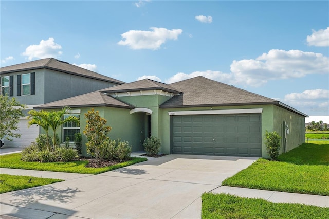 view of front facade with a front yard and a garage