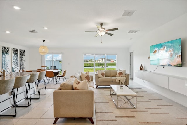 tiled living room featuring ceiling fan