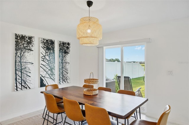 dining space featuring light tile patterned flooring