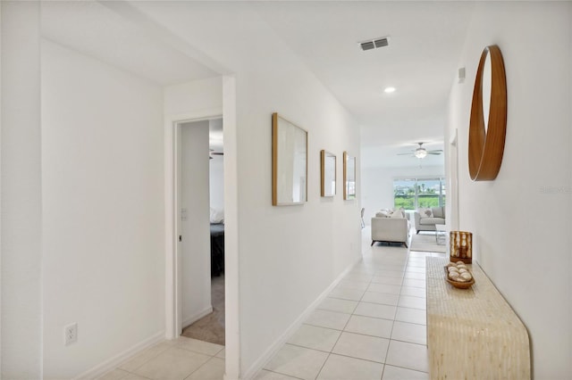 hall with light tile patterned floors