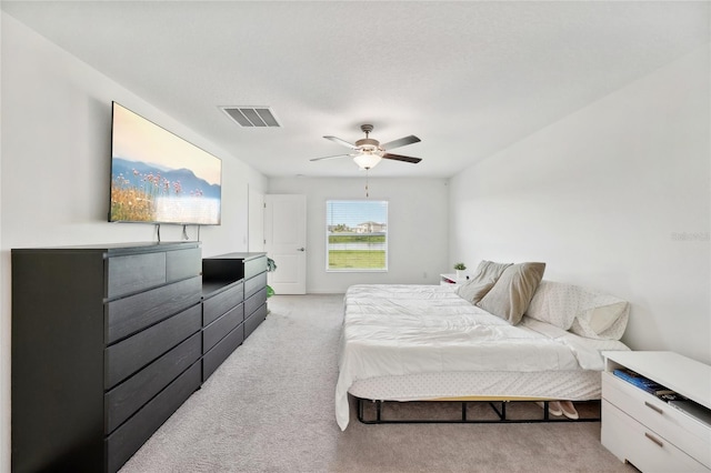 bedroom featuring light carpet and ceiling fan