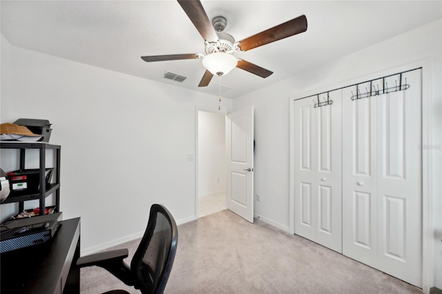 office area featuring ceiling fan and light colored carpet