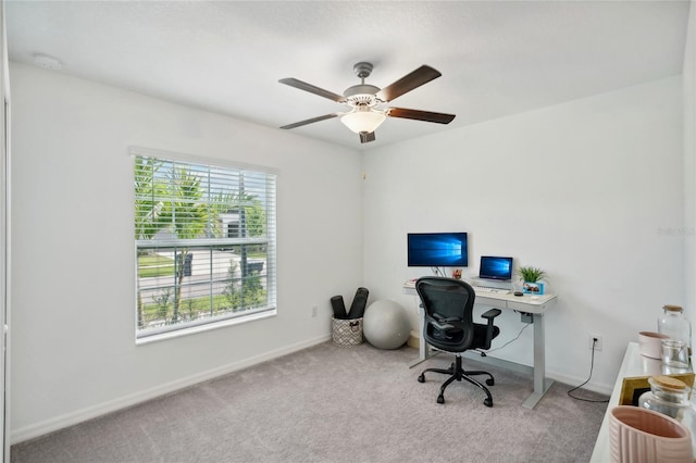 carpeted home office featuring ceiling fan and plenty of natural light