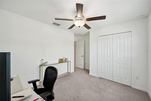 home office featuring ceiling fan and light carpet