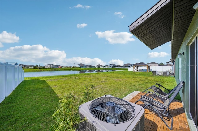 view of yard with a water view and central AC