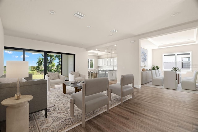 living room with a wealth of natural light and wood-type flooring