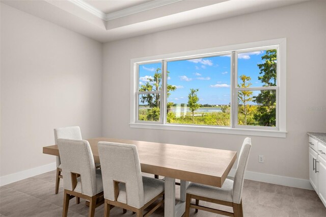 dining area featuring light tile patterned floors and ornamental molding