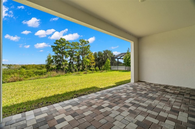 view of patio featuring a lanai