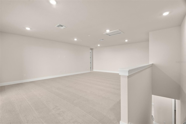 unfurnished room featuring light colored carpet