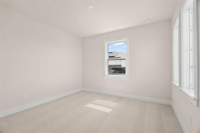 empty room with baseboards and carpet flooring