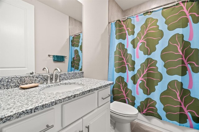 bathroom with tile patterned flooring, vanity, and toilet