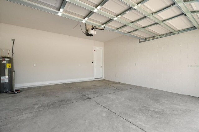 garage with electric water heater and a garage door opener