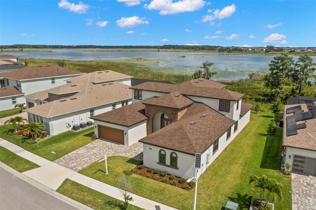 drone / aerial view with a water view and a residential view