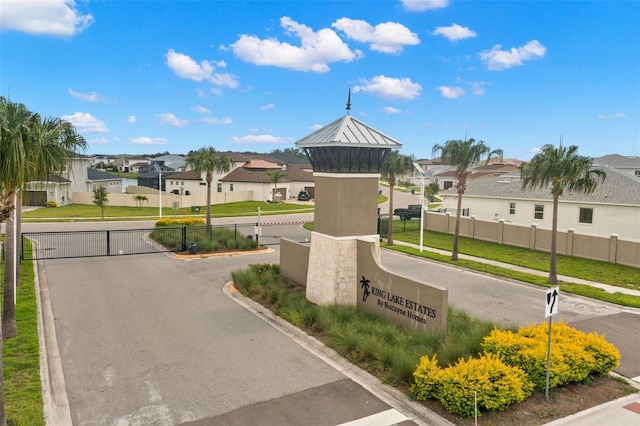 exterior space with a lawn, fence, and a residential view