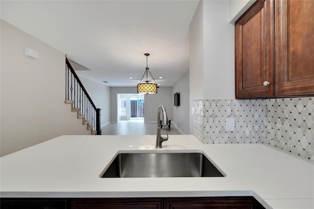 kitchen with pendant lighting, sink, and decorative backsplash