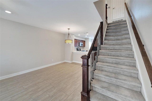 staircase featuring wood-type flooring