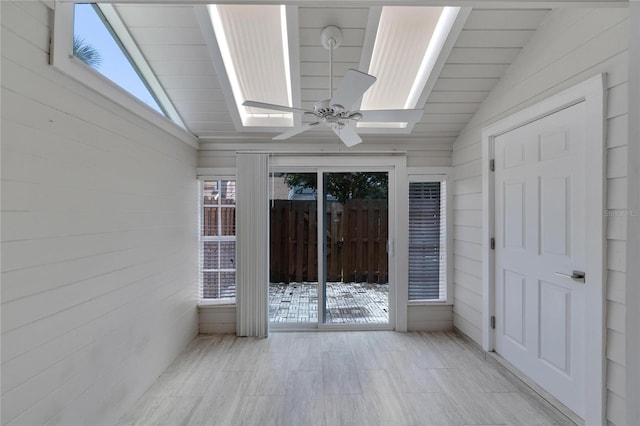 unfurnished sunroom with ceiling fan and lofted ceiling