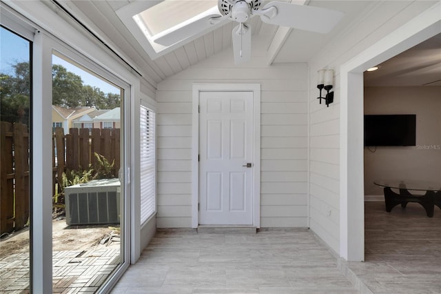 sunroom / solarium with ceiling fan and lofted ceiling with skylight