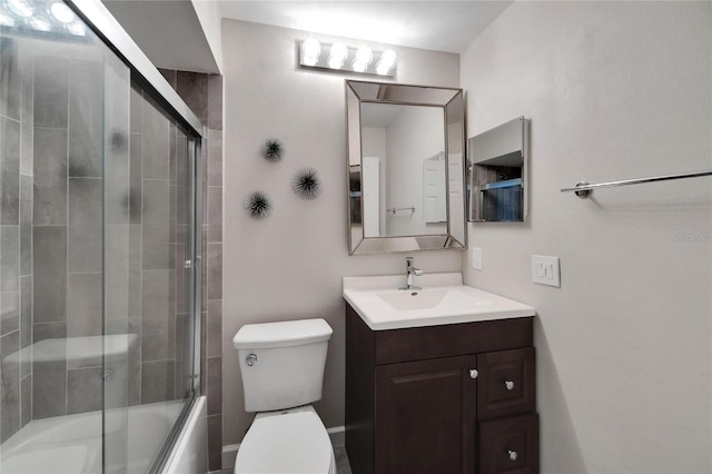 full bathroom with vanity, combined bath / shower with glass door, and toilet